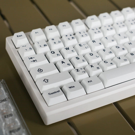 minimal white keycaps on a white keyboard left angle